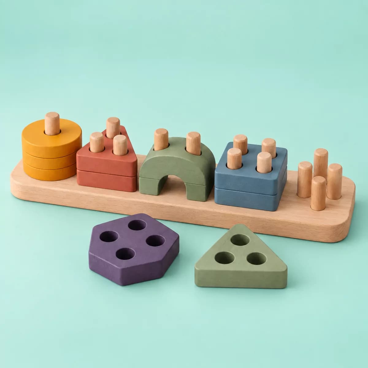Widgy Nest Shape Sorter wooden toy on a mint background